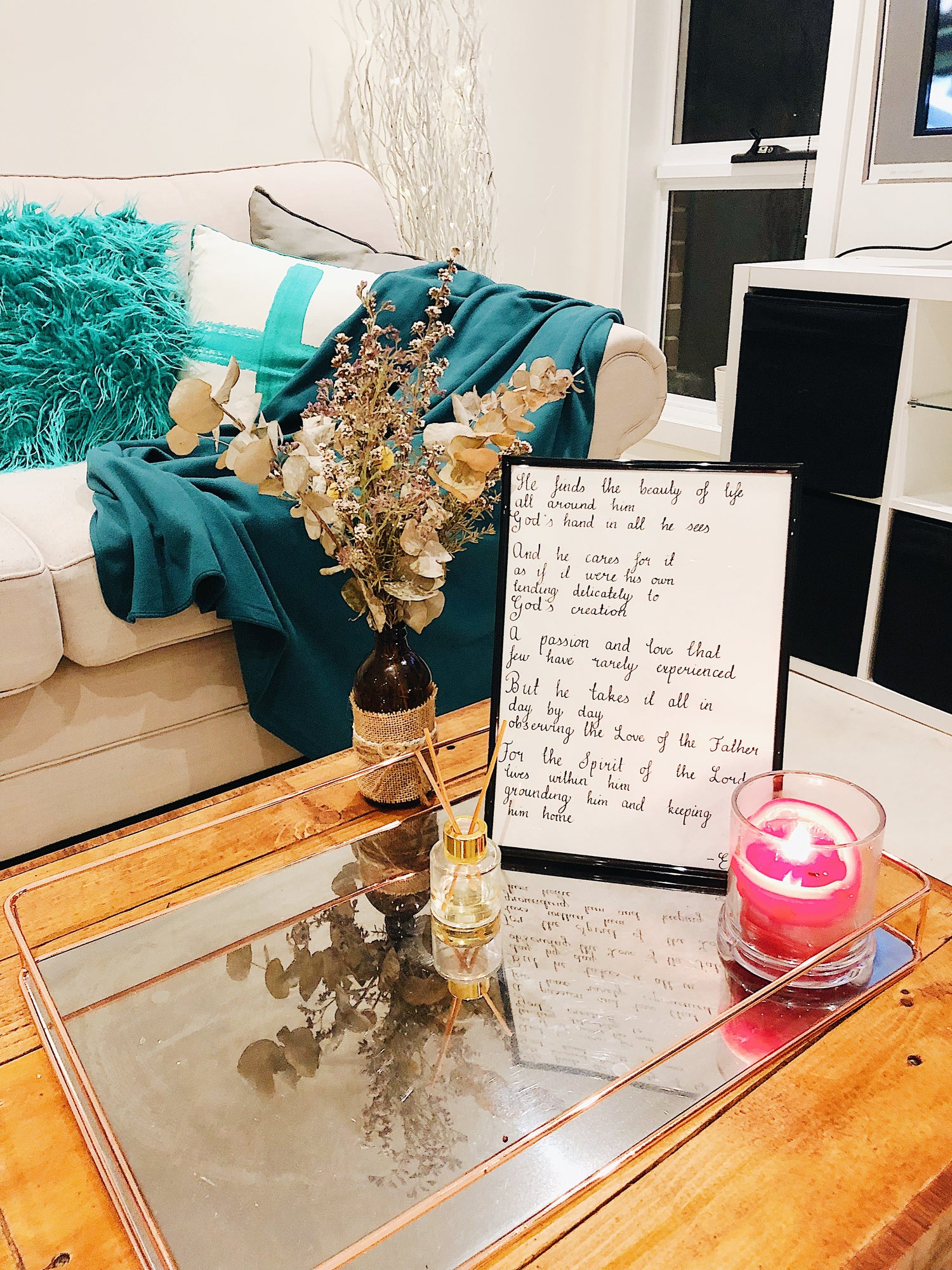 prophetic poem on coffee table, candle in foreground, plant in background, relaxing environment